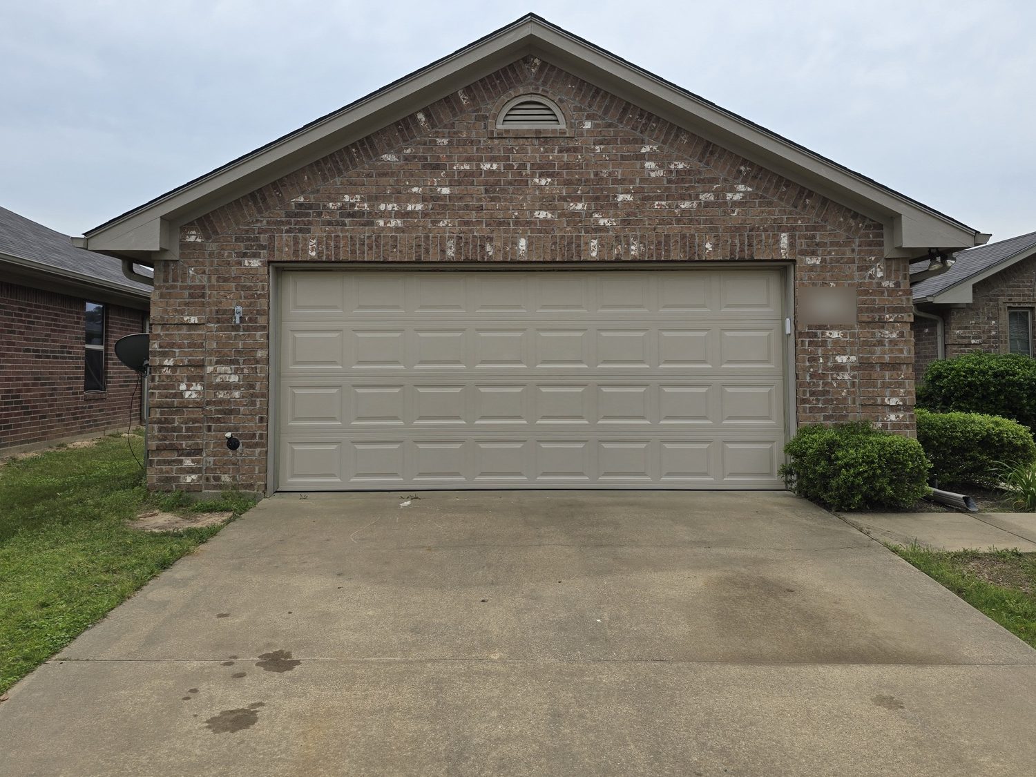 After: the same house with a new tan raised-panel door.