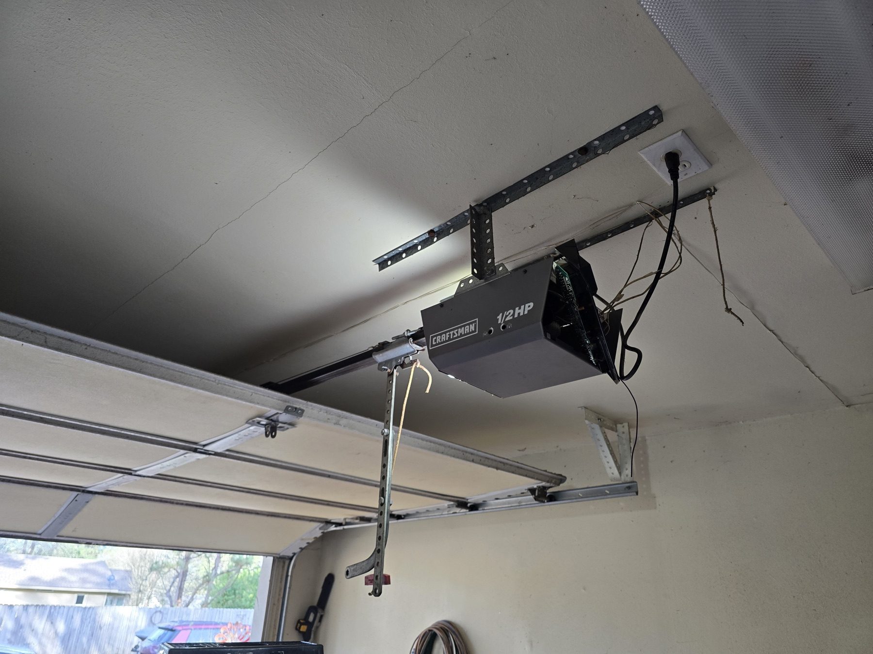 A garage door opener install, mounted to the ceiling.