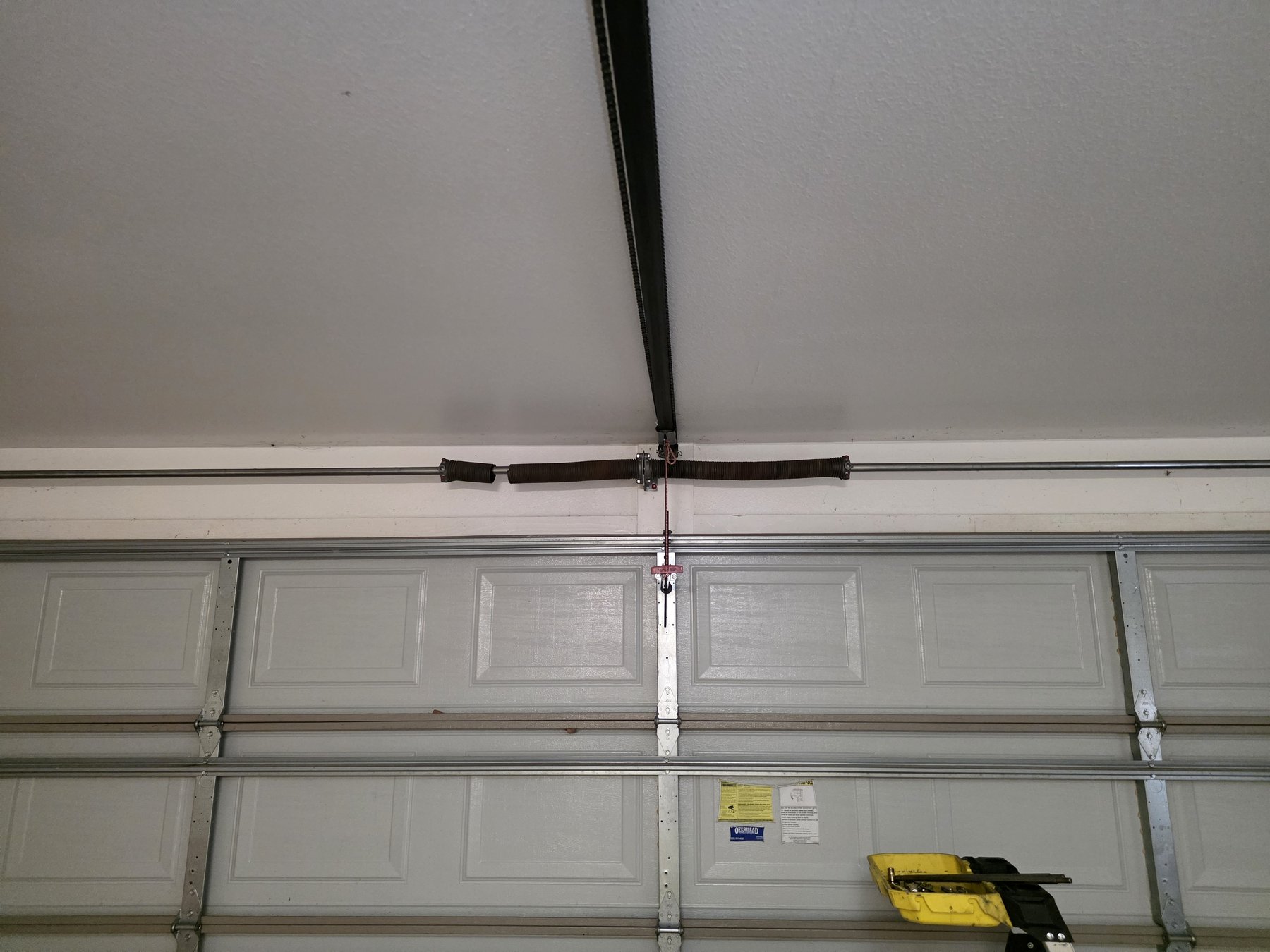 A new torsion spring, installed.
